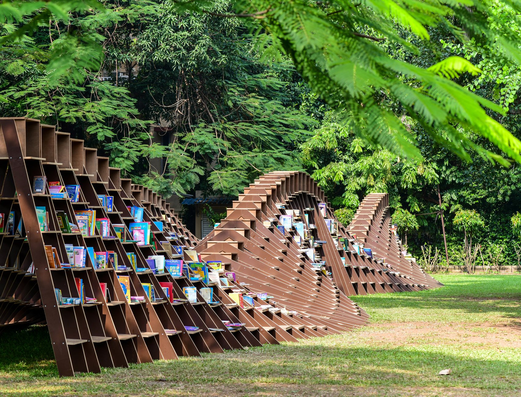 a fluid wooden structure with books on it.