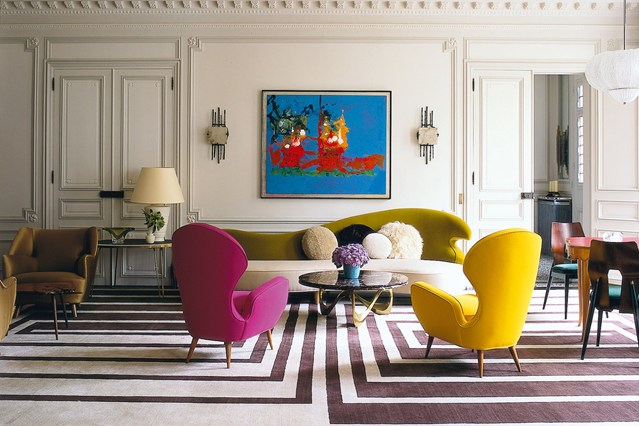 Living space with statement furniture and bright painting
