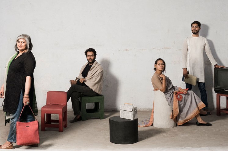 group of people sitting on chairs made of paper mache
